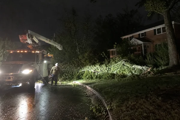 Emergency crew arriving at a storm-damaged property