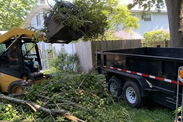 Skid steer loading storm debris