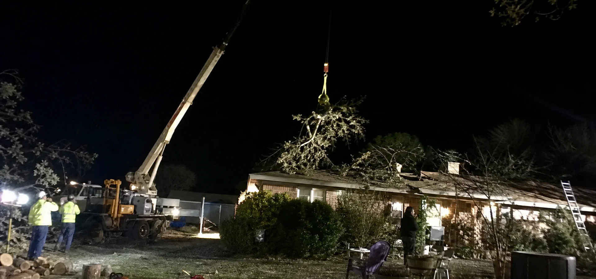 Emergency crane tree removal at night in San Angelo